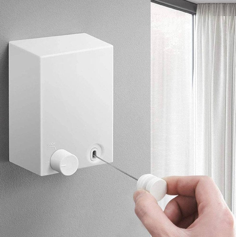 White retractable clothesline installed on wall