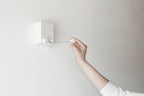 Hand pulling the retractable indoor clothesline
