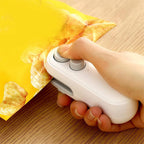 Rechargeable mini bag sealer sealing a snack bag